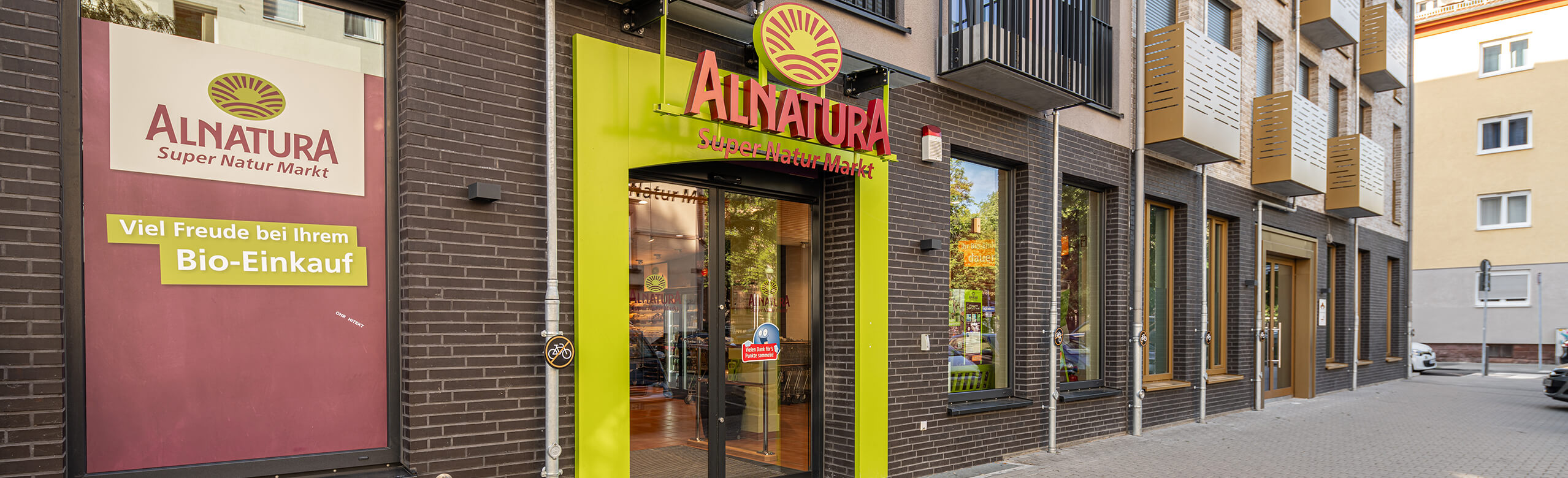 View of the mixed-use building, which houses an Alnatura supermarket on the ground floor and flats above. 